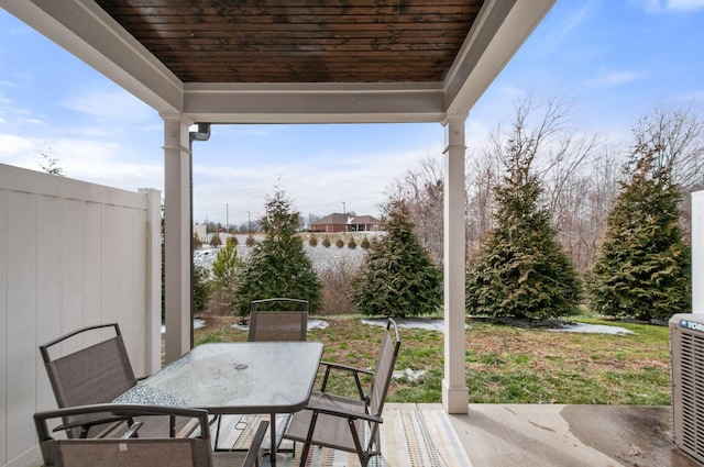 wooden deck featuring central AC, outdoor dining area, a patio area, and fence