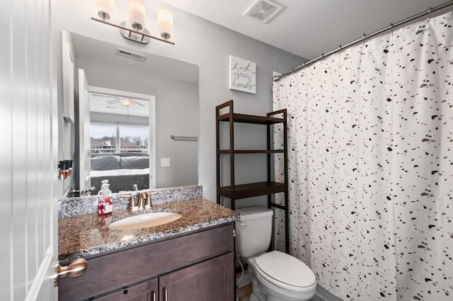 ensuite bathroom with curtained shower, connected bathroom, toilet, vanity, and visible vents