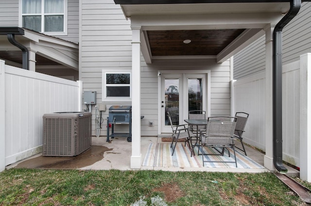 view of patio with central air condition unit, fence, and grilling area