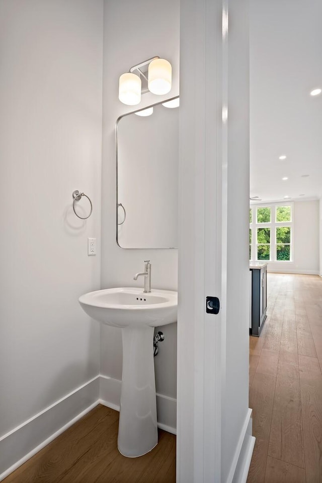 bathroom with baseboards and wood finished floors