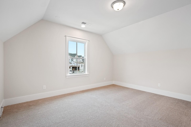 additional living space with vaulted ceiling, carpet flooring, and baseboards