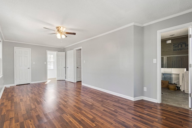 interior space featuring dark wood-style floors, ornamental molding, a ceiling fan, and baseboards