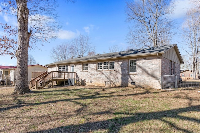 back of property featuring brick siding, a yard, crawl space, a deck, and stairs