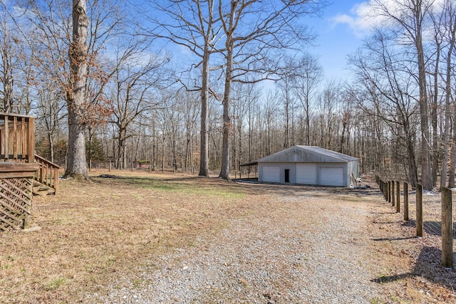 view of yard with a detached garage and an outdoor structure