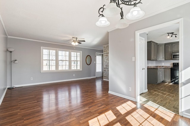 unfurnished living room featuring ornamental molding, ceiling fan with notable chandelier, baseboards, and dark wood-style floors