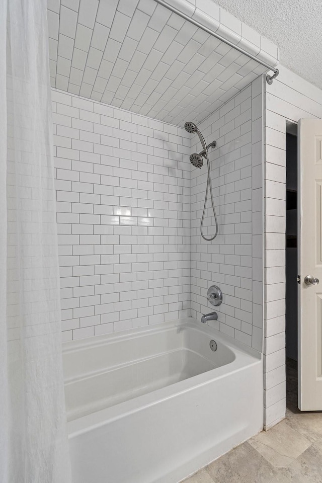 bathroom featuring a textured ceiling and shower / bathtub combination with curtain