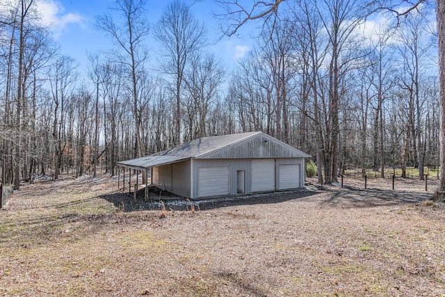 exterior space with a garage and an outbuilding