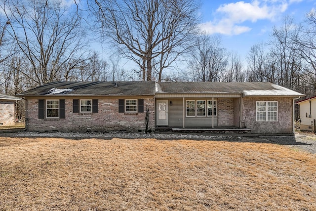 single story home with a front lawn and brick siding