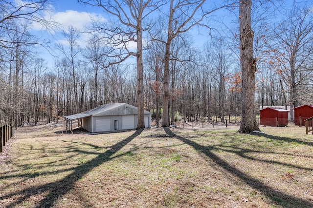 view of yard featuring a garage and an outdoor structure