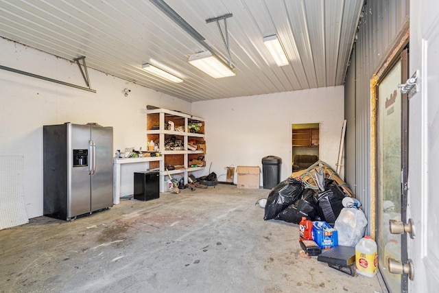 garage with stainless steel fridge