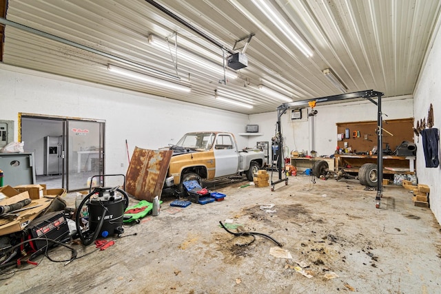 garage with a workshop area and a garage door opener