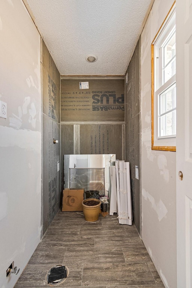 bathroom featuring a textured ceiling and wood finished floors