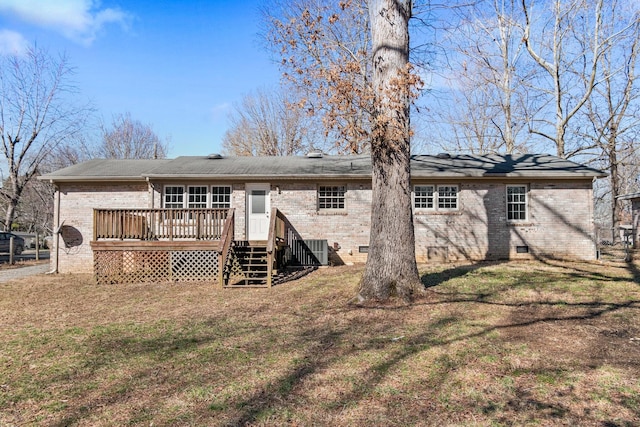 back of property featuring crawl space, brick siding, a yard, and a deck