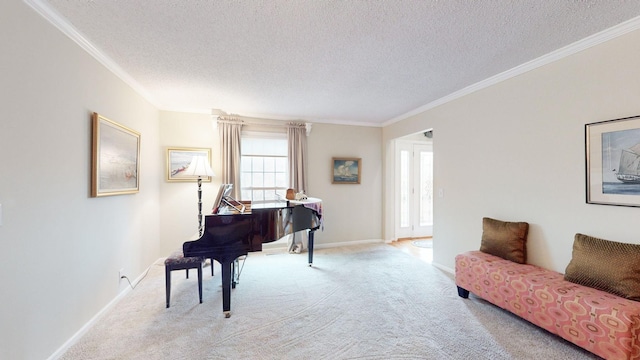 sitting room with baseboards, ornamental molding, a textured ceiling, and light colored carpet