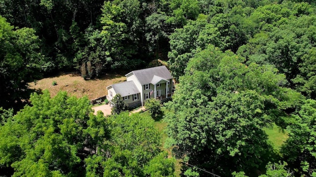 birds eye view of property with a wooded view