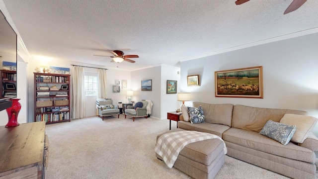 living area featuring ceiling fan, ornamental molding, a textured ceiling, and light colored carpet