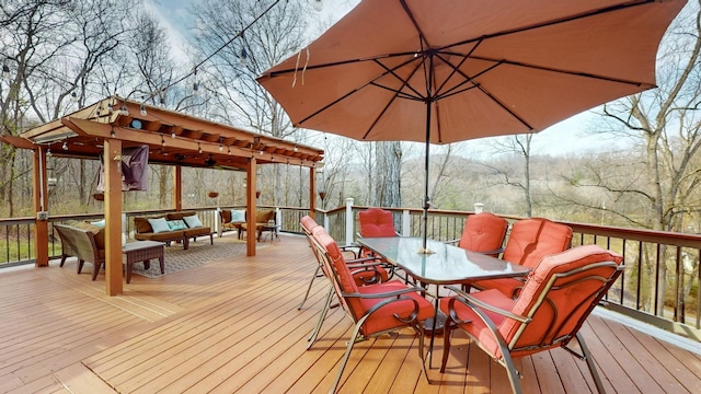 wooden terrace with outdoor dining area and an outdoor living space