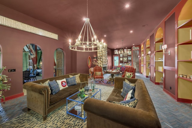 living area with baseboards, a chandelier, arched walkways, and recessed lighting