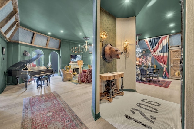 interior space featuring recessed lighting, a fireplace, a decorative wall, and wood finished floors