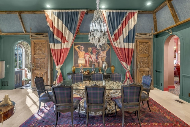 dining room featuring visible vents, arched walkways, and a notable chandelier