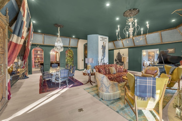 living room featuring a chandelier, arched walkways, and light wood-style floors