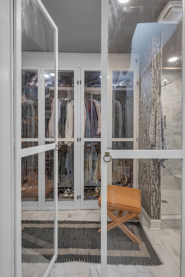 spacious closet featuring marble finish floor