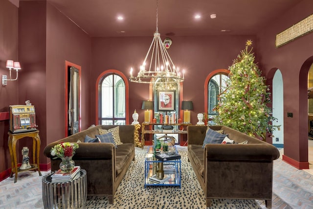 living room with a chandelier, baseboards, and recessed lighting