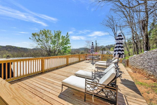 wooden terrace with outdoor dining space