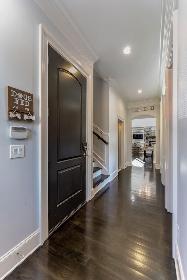 hall featuring baseboards, dark wood-style flooring, stairs, crown molding, and recessed lighting