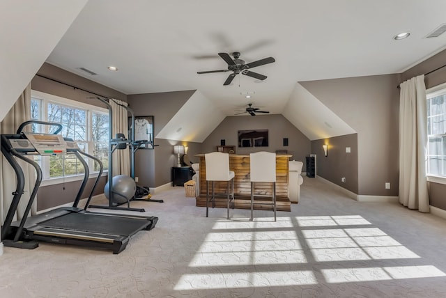 workout room with lofted ceiling, visible vents, light carpet, and baseboards