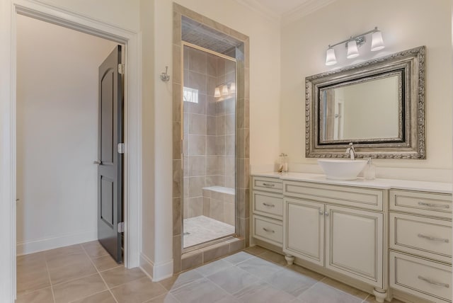 bathroom with tile patterned flooring, vanity, baseboards, ornamental molding, and a stall shower