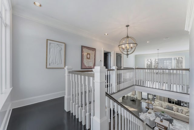 hall featuring baseboards, ornamental molding, an upstairs landing, a notable chandelier, and recessed lighting