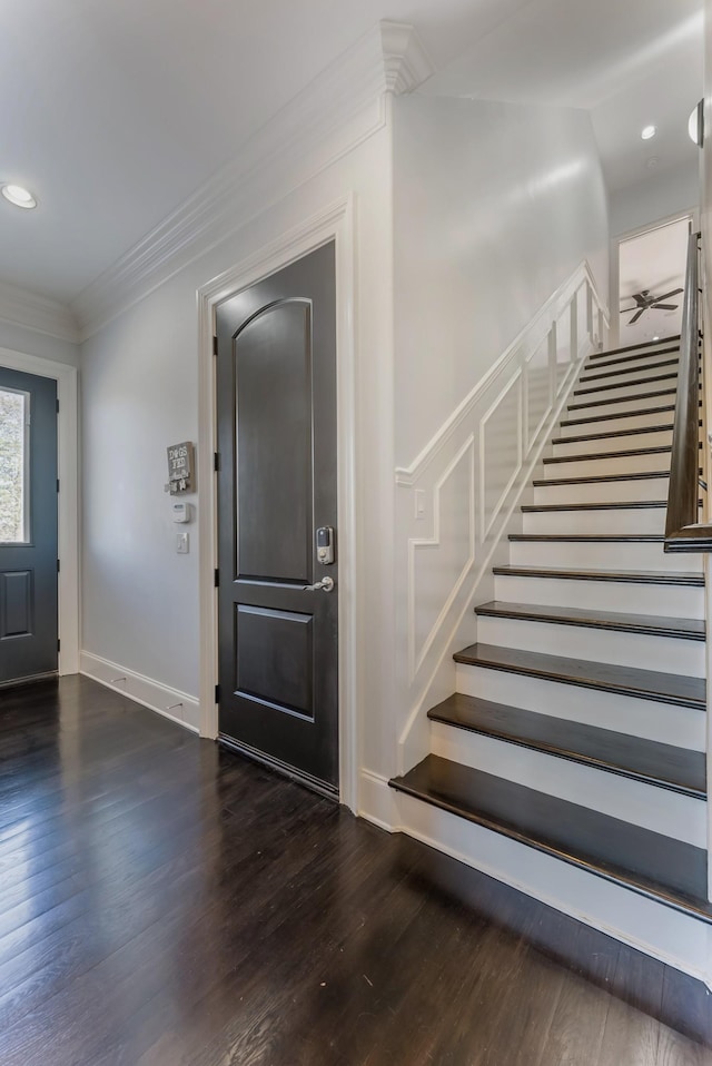 foyer with recessed lighting, dark wood-type flooring, ornamental molding, a ceiling fan, and stairs