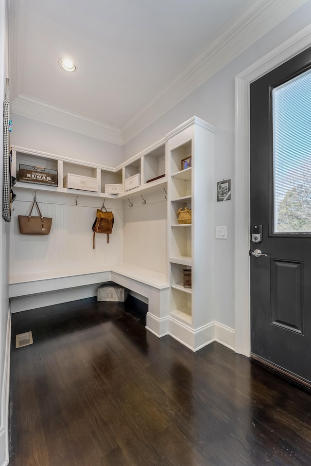 mudroom featuring dark wood-type flooring, ornamental molding, and baseboards