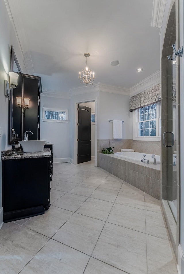 full bathroom featuring a garden tub, vanity, crown molding, and tile patterned floors