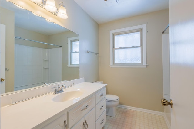 bathroom featuring visible vents, baseboards, toilet, tile patterned floors, and vanity