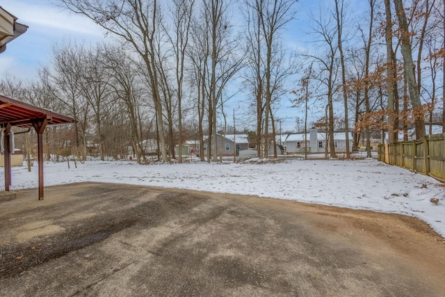 snowy yard with fence