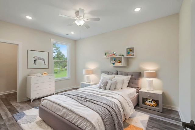 bedroom with dark wood-style floors, baseboards, and recessed lighting