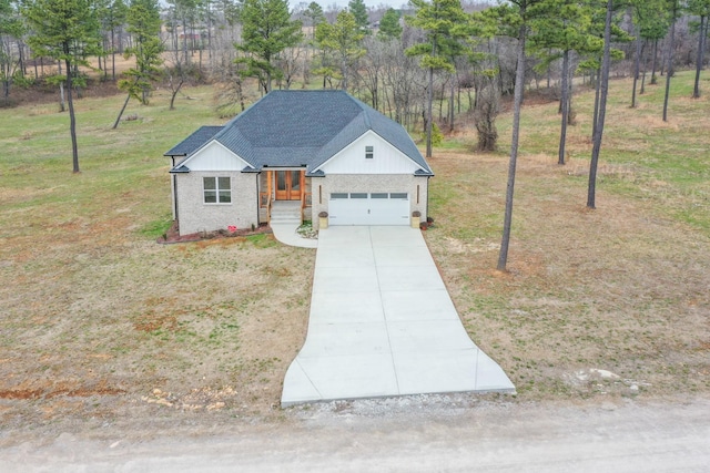 modern farmhouse style home with a shingled roof, concrete driveway, covered porch, a front yard, and a garage