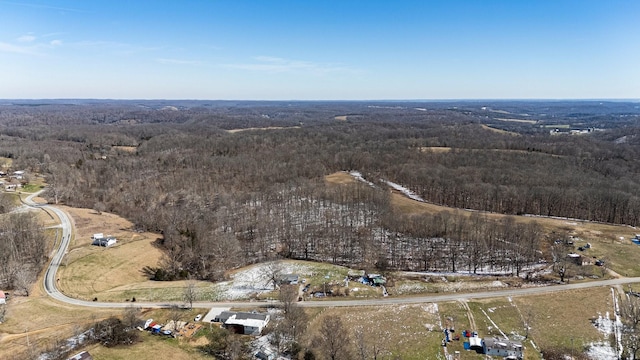 birds eye view of property featuring a view of trees