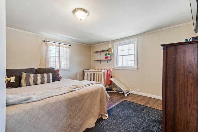 bedroom featuring crown molding, baseboards, and wood finished floors