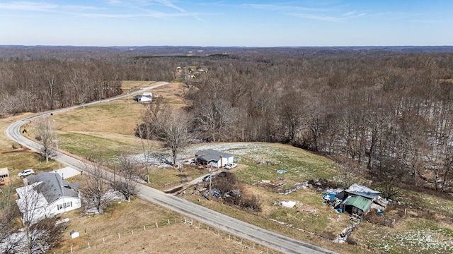 birds eye view of property with a view of trees