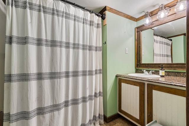 bathroom with crown molding and vanity