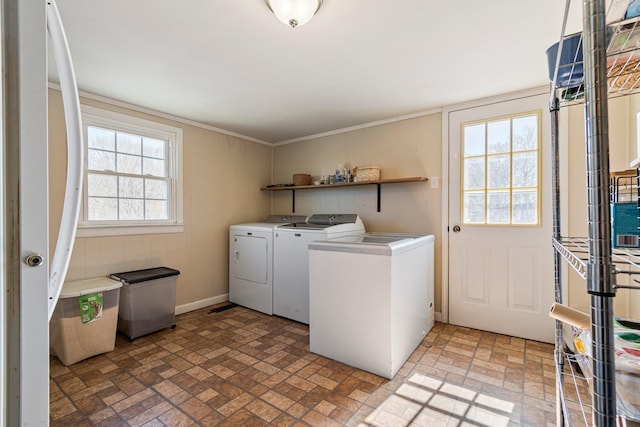 washroom with laundry area, ornamental molding, brick floor, and washer and dryer