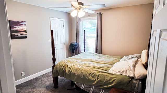 bedroom featuring ceiling fan, dark colored carpet, and baseboards