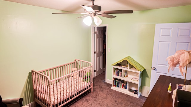 bedroom with dark colored carpet and ceiling fan