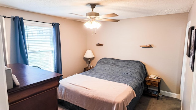 bedroom featuring carpet floors, ceiling fan, baseboards, and a textured ceiling