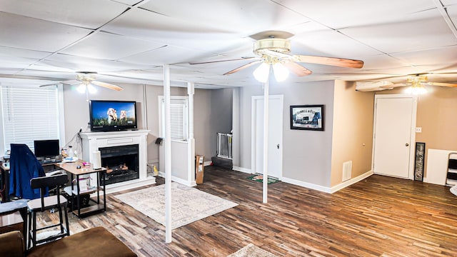 living room featuring dark wood-style floors, visible vents, and a ceiling fan