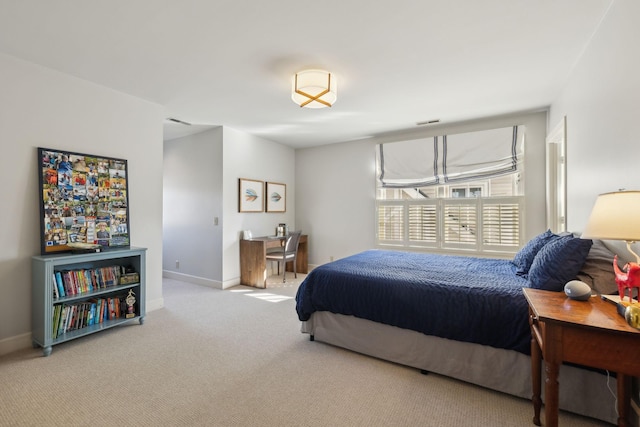 carpeted bedroom featuring visible vents and baseboards