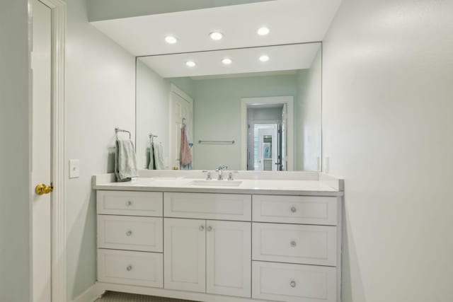 bathroom featuring recessed lighting, vanity, and baseboards